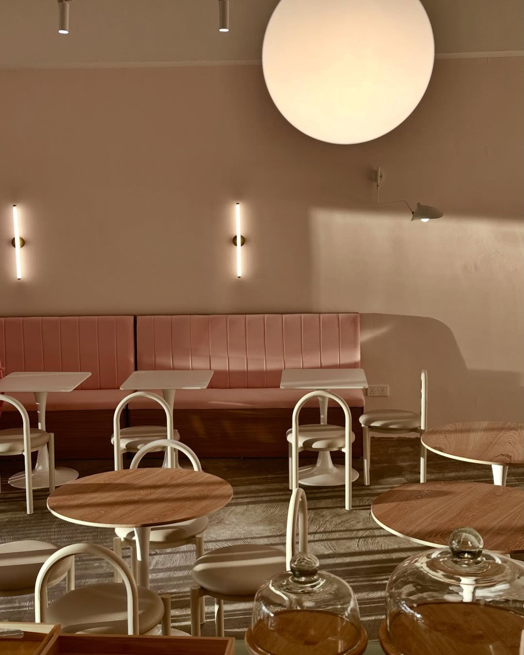 Fika's warm interior — pink banquette seating and soft lighting